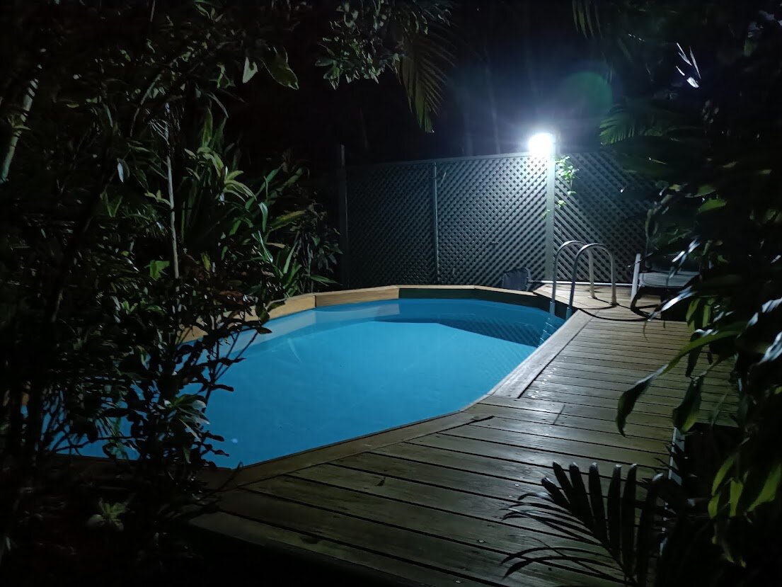 Muri Retreat pool and tropical gardens illuminated at night