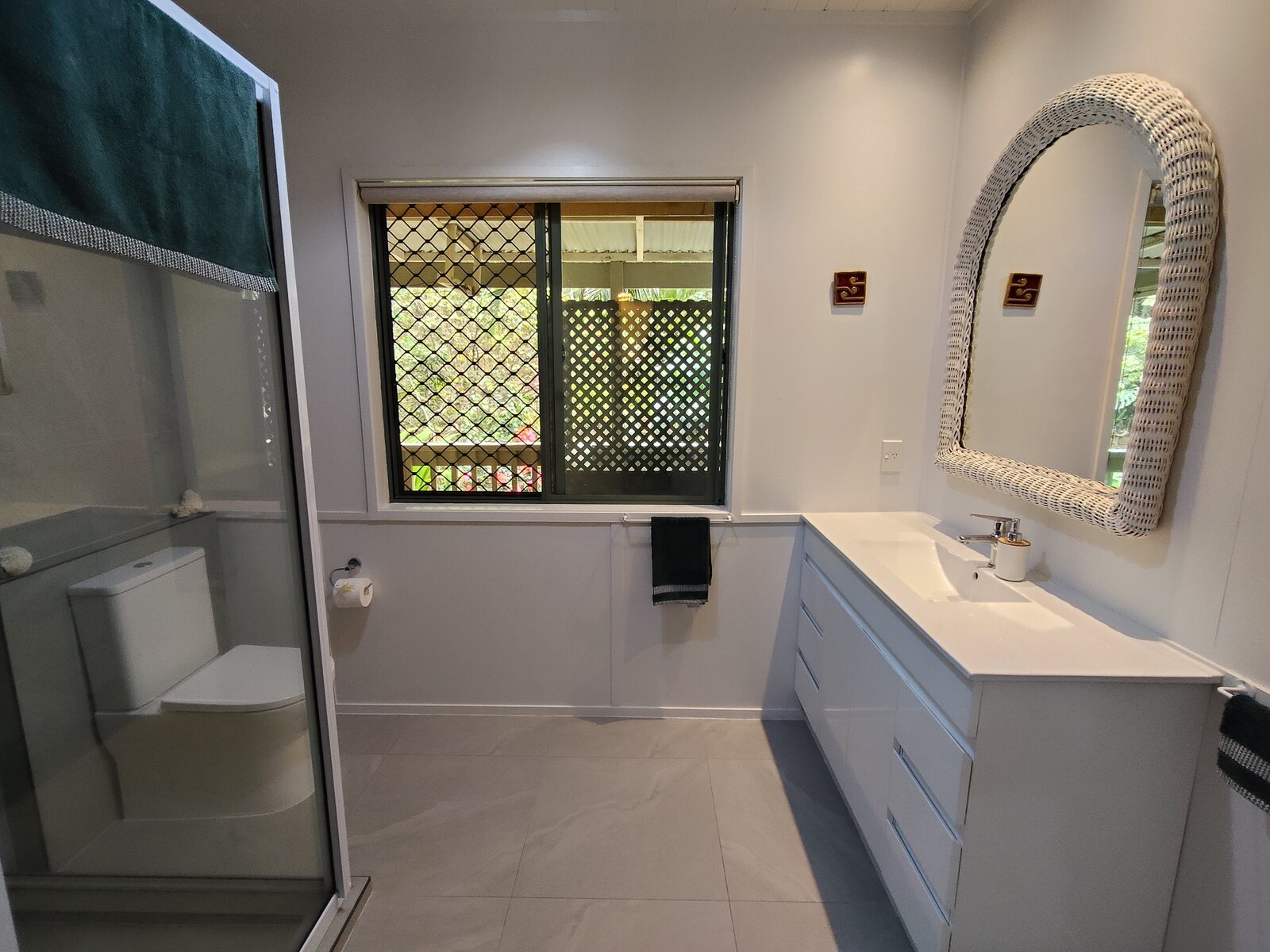 Modern bathroom vanity and shower in Kaute