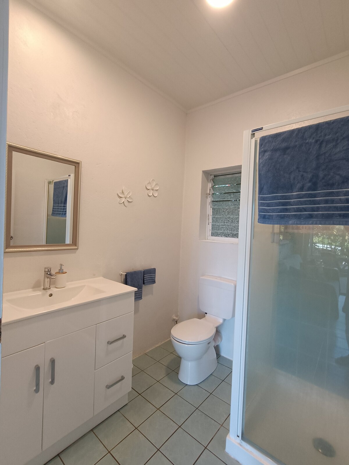 Kaute private bathroom with shower and vanity