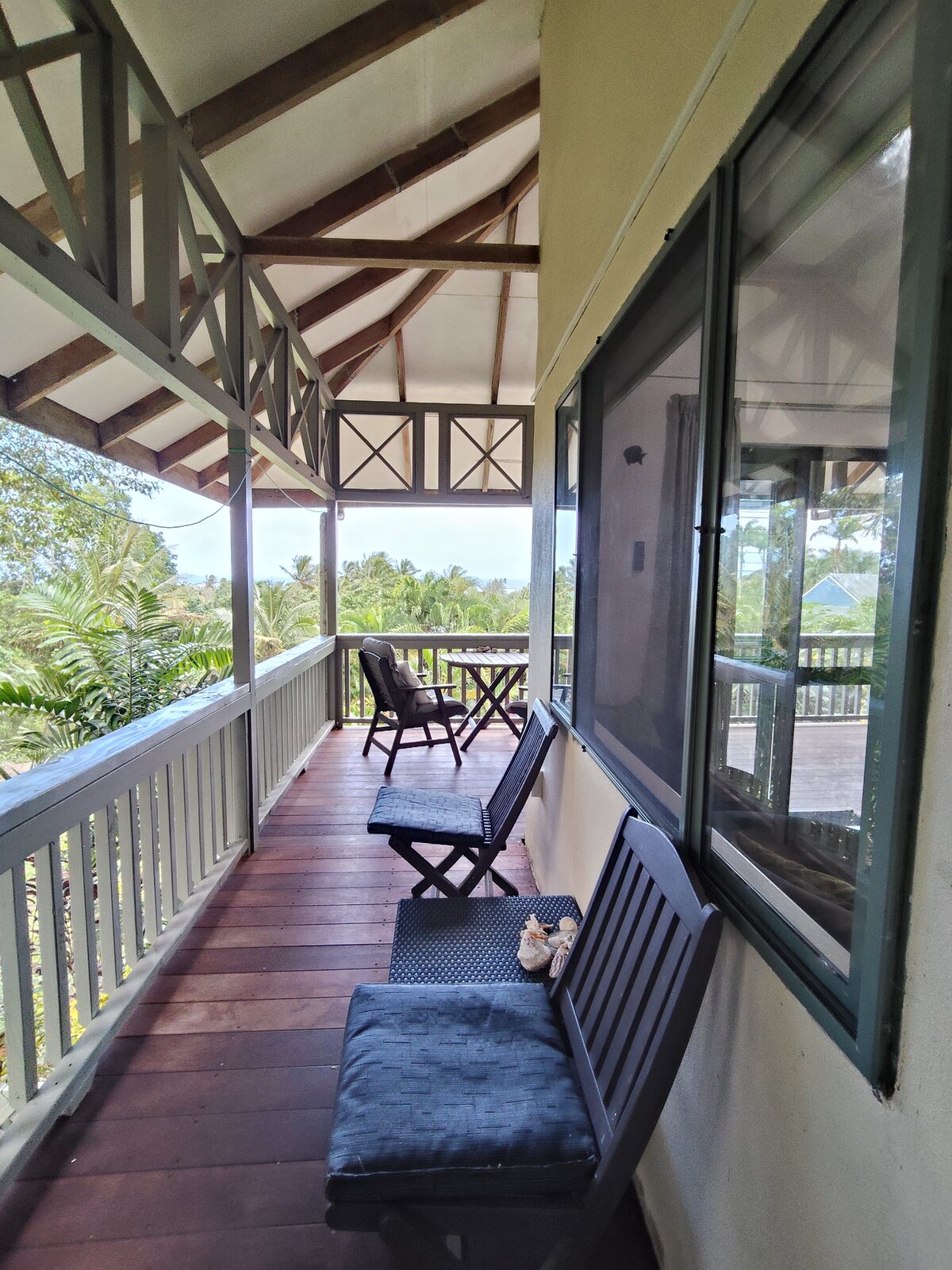Kukupa wraparound veranda with seating and island views
