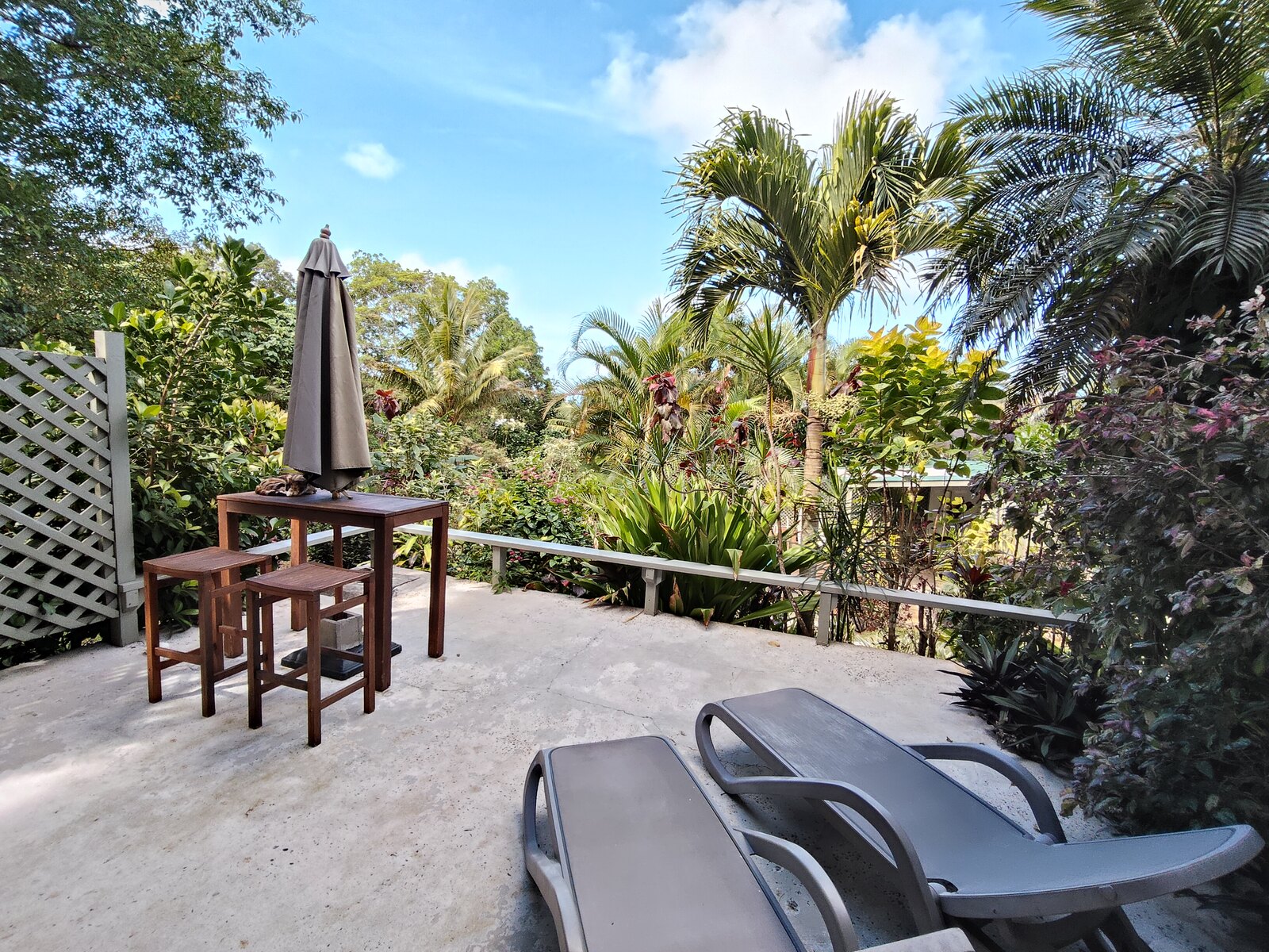 Moko outdoor dining table overlooking tropical gardens