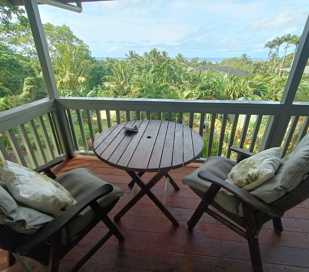 Private balcony seating overlooking tropical gardens and Muri Lagoon